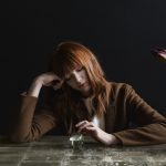 Redhead Girl Sitting At Table