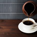 Coffee,In,White,Cup,And,Clay,Cezve,On,Wooden,Background.