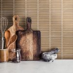Kitchen,Utensils-wooden,Spoons,And,Cutting,Boards,On,Stone,Table,Close